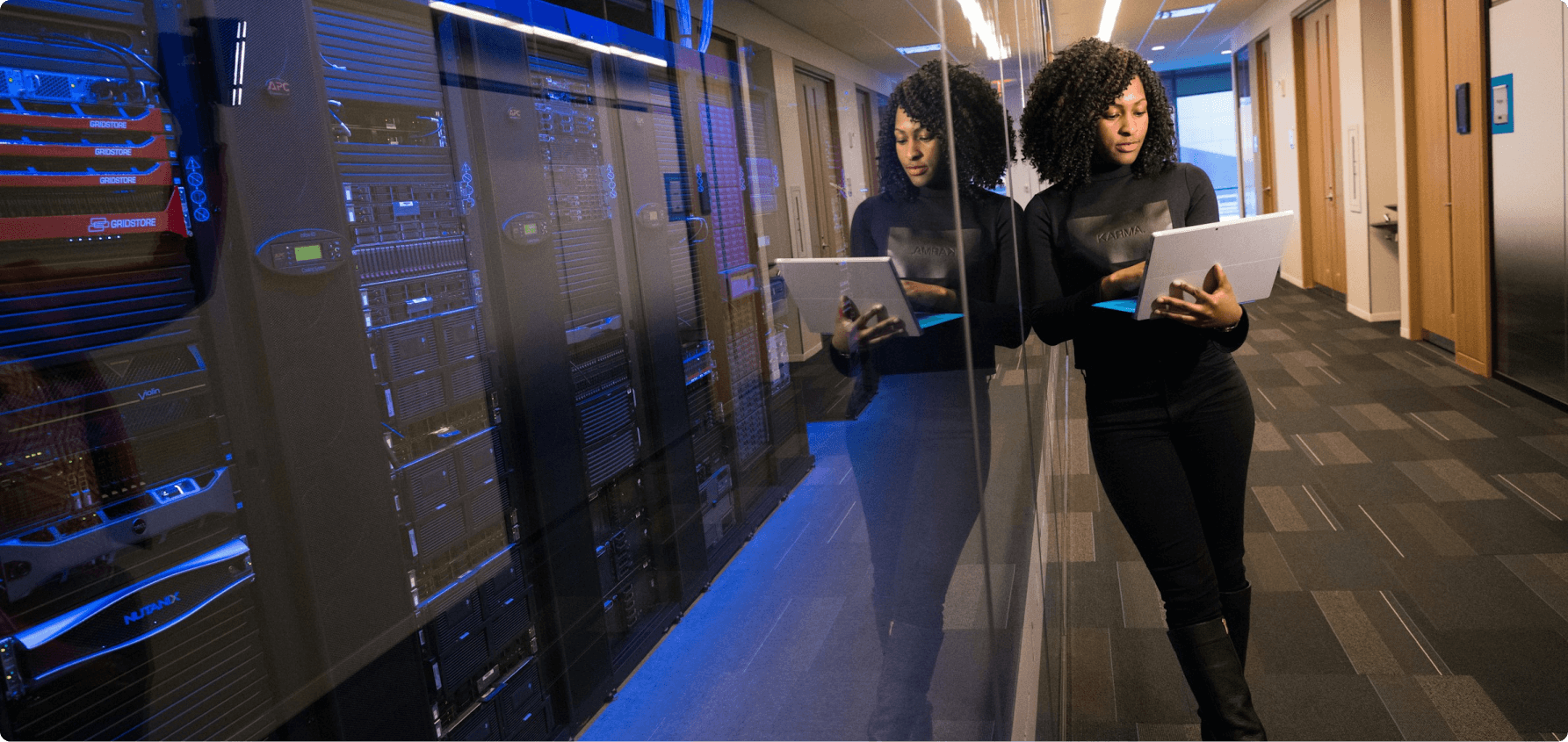 A woman standing and holding a computer